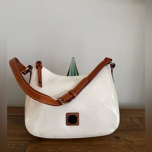 Dooney and Bourke small bag patent leather white with tan leather strap
